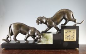 Irenee Rochard. A French Art Deco bronzed spelter, black marble and green onyx mantel clock,