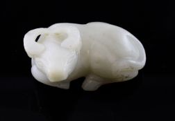 A Chinese hardstone figure of a recumbent buffalo, the stone of pale celadon tone with some white