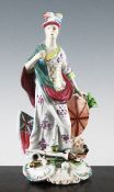 A Derby figure of Britannia, late 18th century, modelled with trophies and a lion at her feet, on a