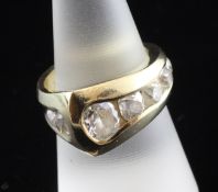 An 18ct gold seven stone diamond dress ring, of asymmetrical form, set with graduated stones, size