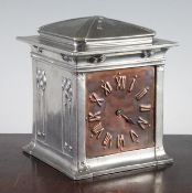 A Liberty Tudric pewter mantel timepiece, the squared cased decorated with panels of honesty, with