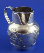 A Victorian silver cream jug, decorated with topers and trees, inscribed with `Liverpool Polo Club