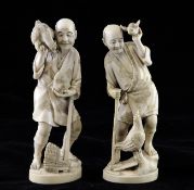 Two Japanese ivory figures of farmers holding chickens, early 20th century, on oval bases, one