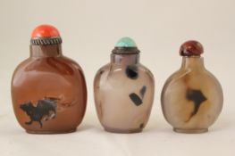 Three Chinese chalcedony snuff bottles, 19th / 20th century, the first carved with an animal to a