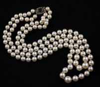 A late 1950`s double strand cultured pearl necklace, with oval 9ct gold, sapphire and seed pearl