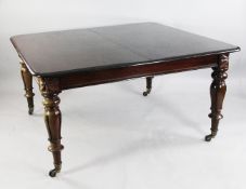 A Victorian mahogany extending dining table, with three extra leaves, on turned stiff leaf supports
