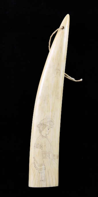 A scrimshaw walrus tusk, decorated with a lady in Victorian costume, 2in.