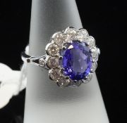 An 18ct white gold, tanzanite and diamond cluster ring, of oval form, with an estimated tanzanite
