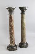 A pair of circular variegated marble columns, each on a stepped circular plinth base, H.3ft 10in.