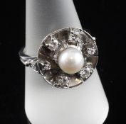 A white gold, cultured pearl and diamond set target cluster ring, size Q.