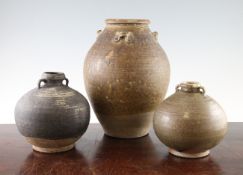 Two Thai Sawankhalok ring-handled bottles and an Annamese pottery jar, 15th / 16th century, the