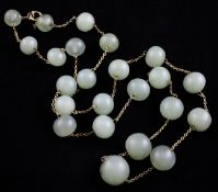 A gold and jade bead necklace, with graduated rounded jade beads, 38in.
