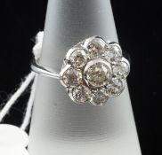 An 18ct white gold and old cut diamond cluster ring, of flowerhead design, with and estimated total