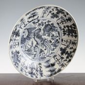 A Chinese Ming blue and white dish, Swatow 17th century, painted with a central phoenix amid rocks