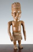 A Central African carved hardwood figure, of a male standing with line carved hat, probably Belgian