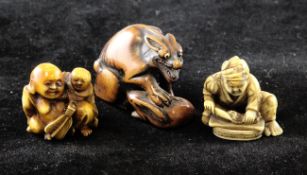 Three Japanese netsuke, 19th / early 20th century, the first in boxwood carved as a wolf resting