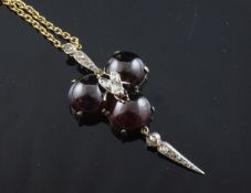 A Victorian style gold, cabochon garnet and diamond set drop pendant, with central bug motif, on a