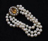 A late 1950`s triple strand cultured pearl bracelet, with oval 9ct gold, citrine and cultured pearl