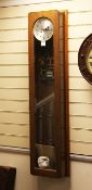 A Synchronome of London oak cased electric wall clock, with glazed door, 51in.