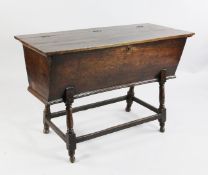A 19th century oak and elm dough bin, of typical form with hinged lid and turned underframe W.3ft
