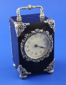 A George V silver mounted tortoiseshell carriage clock, with ornate scroll silver mounted angles