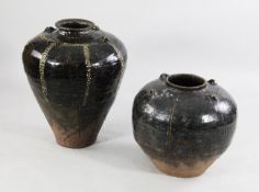 A Burmese stoneware glazed baluster shaped storage jar, with four loop handles, together with a
