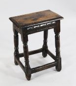 A 17th century oak joynt stool, with rectangular top and chip carved frieze, on turned supports