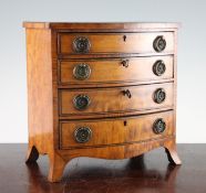 A 19th century miniature satinwood bowfront chest, of four long graduated drawers, on swept bracket