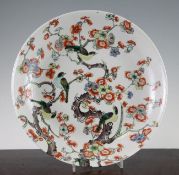 A Chinese famille verte dish, late 19th century, painted with birds perched amid prunus branches,