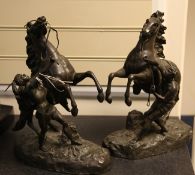 After Cousteau. A pair of patinated bronze Marly horses, 15.75in.