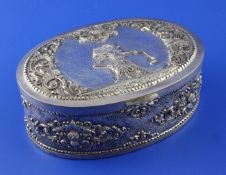 A 20th century Indonesian 800 standard silver oval lidded box, decorated with foliate scrolls and