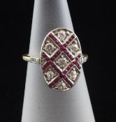 An early 20th century French? belle epoque gold, ruby and diamond oval cluster ring, with chequered