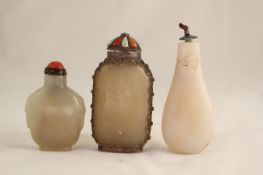 Three Chinese jade snuff bottles, 19th / early 20th century, the first a white jade pear shaped