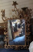 A George III carved giltwood wall mirror, with pierced acanthus C scroll frame mounted with