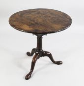 A Georgian circular yew wood tripod table, with birdcage action, gun barrel turned central column,