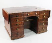 An unusual 19th century mahogany kneehole desk, the top with drop leaf sides over eleven drawers
