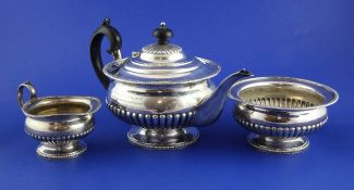 A George V three piece silver teaset, of demi-fluted squat circular form, with HM Prison Holloway