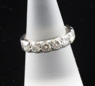 An 18ct white gold and seven stone diamond half hoop ring, with an estimated total diamond weight