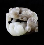 A Chinese pale celadon and brown jade group of cats, two fighting a butterfly, 5.1cm.