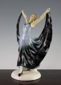 An Art Deco Goldscheider style figure of a girl, modelled with arms held aloft and trailing long