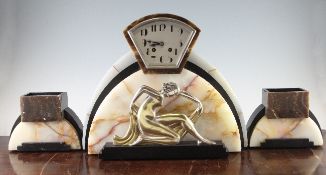 A French Art Deco coloured marble clock garniture, applied with a silvered bronze figure of a scarf