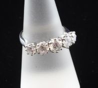 An18 ct white gold graduated five stone half hoop diamond ring, the round cut stones with an