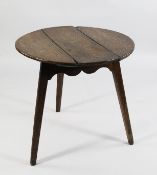A 19th century oak cricket table, with three section plank top, on tapering supports, H.2ft 4in.