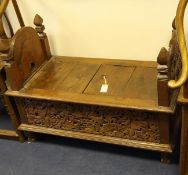 An Indonesian carved teak dowry chest, Madura, 19th century, the sides carved in high relief with