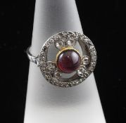 An Edwardian platinum, cabochon almandine garnet and old cut diamond set dress ring, of pierced