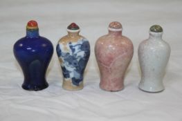 Four Chinese porcelain baluster-shaped snuff bottles, 1800-1900, the first painted in underglaze