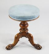 A 19th century walnut circular revolving piano stool, stamped Gillows, with blue upholstered seat