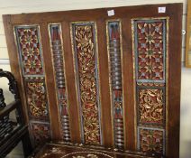 An Indonesian polychrome carved teak panel, 19th / 20th century, with flower carved and spindle