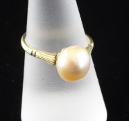 An 18ct gold and solitaire cultured pearl ring, the shank with fluted tapering shoulders, size O.