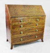 A George III mahogany boxwood strung bureau, the fall front with fitted interior over two short and